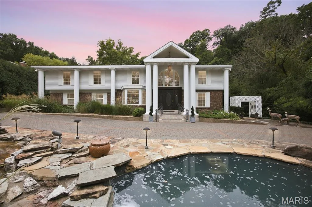 Expansive paved driveway leading to a grand portico entrance with substantial columns — 76 River Valley Drive, Chesterfield, MO 63017