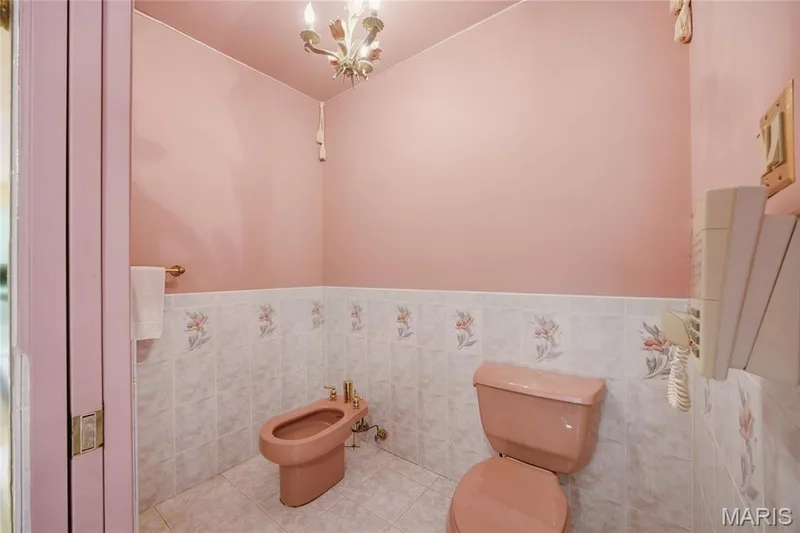Pink walls with decorative tiled wainscoting and coordinating floor tiles — 76 River Valley Drive, Chesterfield, MO 63017