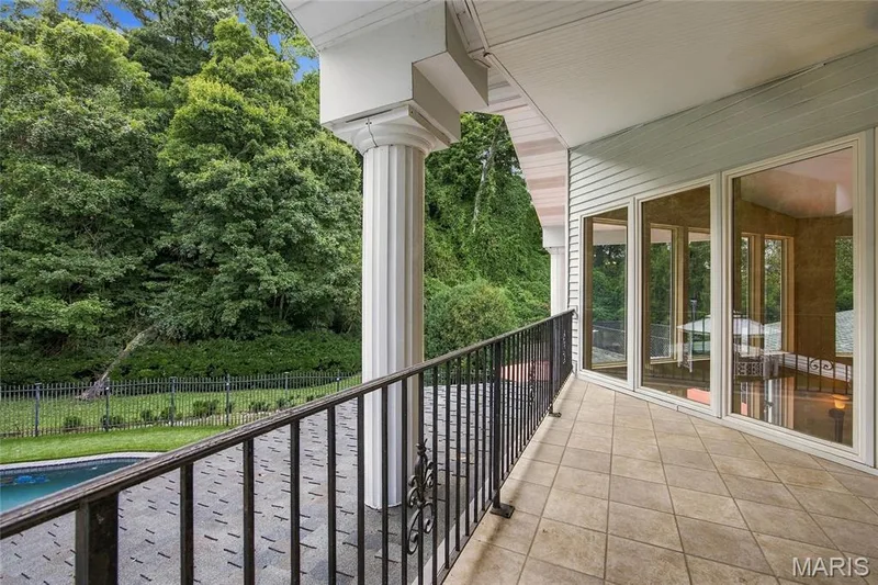 Covered Balcony off primary suite overlooking the pool and backyard — 76 River Valley Drive, Chesterfield, MO 63017