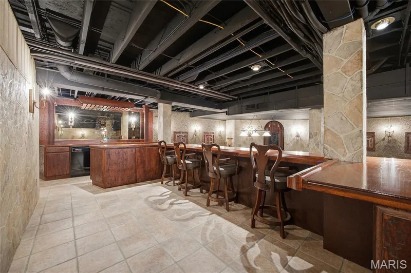 Basement has an elevated bar level seating overlooking the rest of the basement — 76 River Valley Drive, Chesterfield, MO 63017