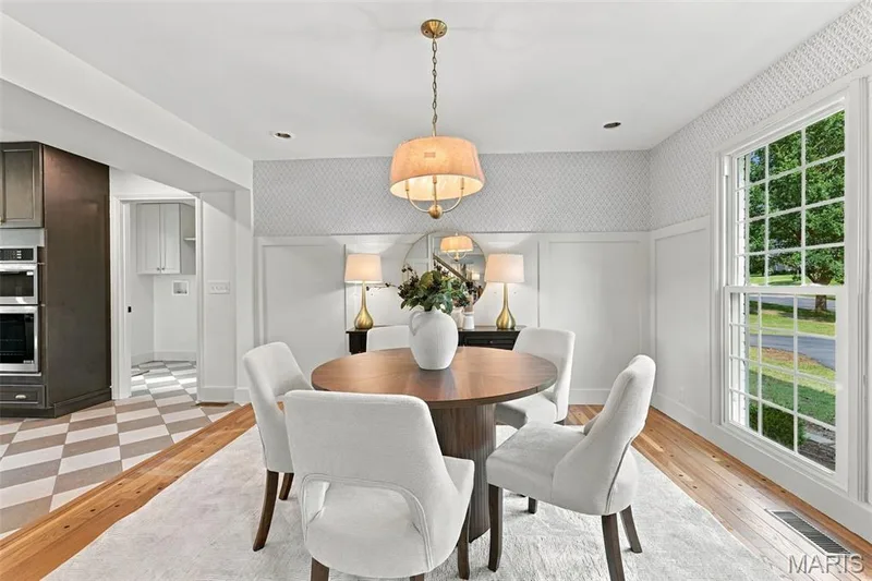 Renewed Hardwood flooring, new picture window, board and batten wall detailing, wallpaper, recessed lighting, and a drum-shade chandelier — 621 Claymont Estates Drive, Chesterfield, MO 63017