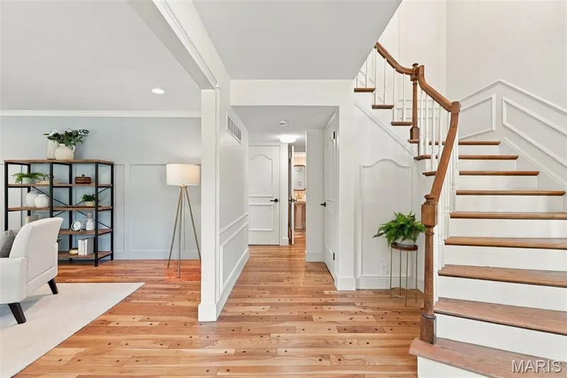Beautiful Entry with Renewed Hardwood flooring throughout the home, featuring a staircase with a wood handrail and white balusters — 621 Claymont Estates Drive, Chesterfield, MO 63017