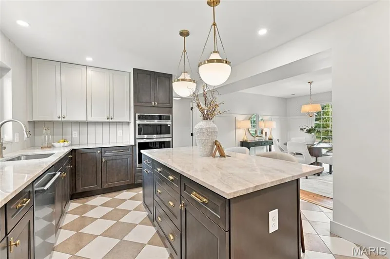 New Two-tone custom cabinetry, quartz countertops, stainless steel appliances, central island with seating, pendant lighting, shiplap backsplash and checkered tile flooring — 621 Claymont Estates Drive, Chesterfield, MO 63017