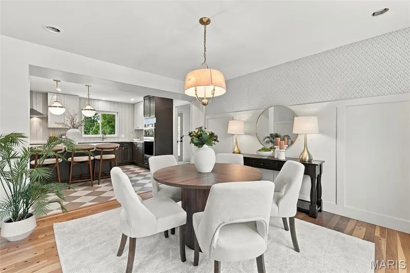 Dining attached to Kitchen with Renewed Hardwood flooring, designer board and batten wall detailing, wallpaper, recessed lighting, and a drum-shade chandelier — 621 Claymont Estates Drive, Chesterfield, MO 63017