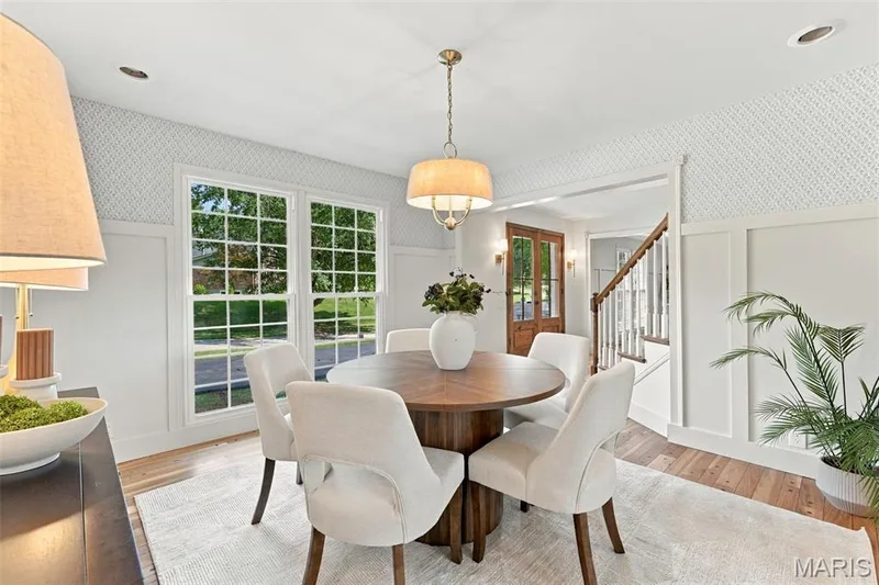 Renewed Hardwood flooring, new picture window, board and batten wall detailing, wallpaper, recessed lighting, and a drum-shade chandelier — 621 Claymont Estates Drive, Chesterfield, MO 63017
