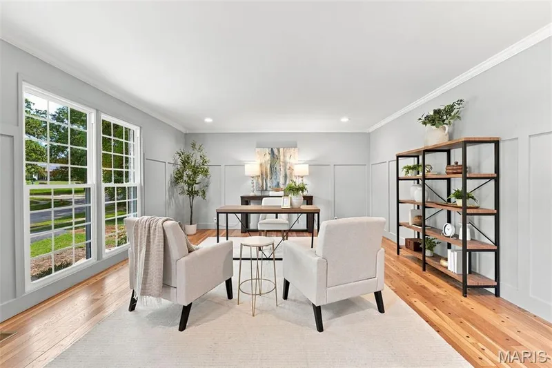 Spacious room Living Room or Office featuring renewed hardwood flooring, extensive wainscoting, crown molding, and new large multi-pane windows — 621 Claymont Estates Drive, Chesterfield, MO 63017