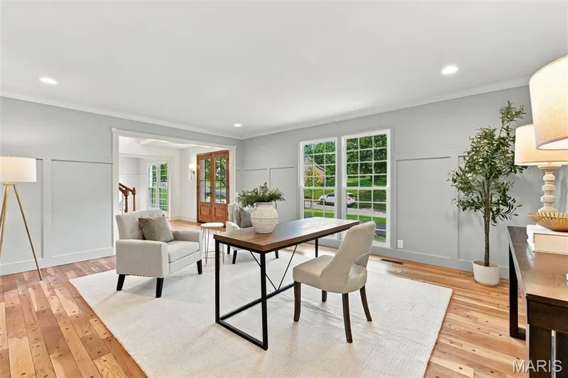 Spacious room Living Room or Office featuring renewed hardwood flooring, extensive wainscoting, crown molding, and large multi-pane windows — 621 Claymont Estates Drive, Chesterfield, MO 63017