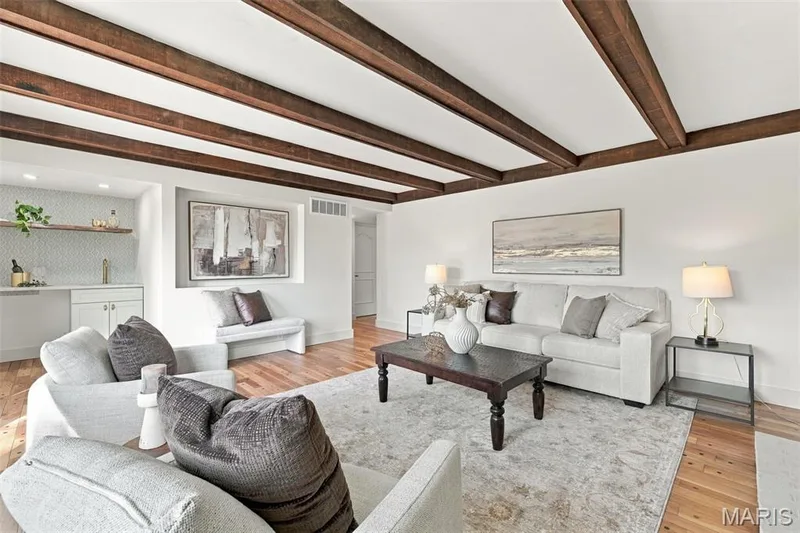 Nice Size Family Room with renewed hardwood flooring, exposed wood beams, built-in wet bar, and recessed wall niche — 621 Claymont Estates Drive, Chesterfield, MO 63017