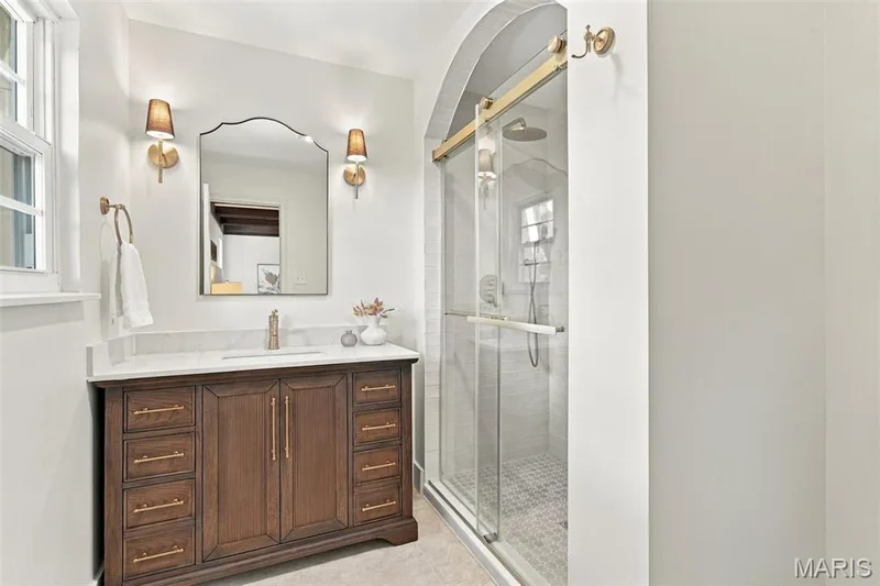 Wood-finish vanity with Arched walk-in shower, New Vanity and gold-finish hardware — 621 Claymont Estates Drive, Chesterfield, MO 63017