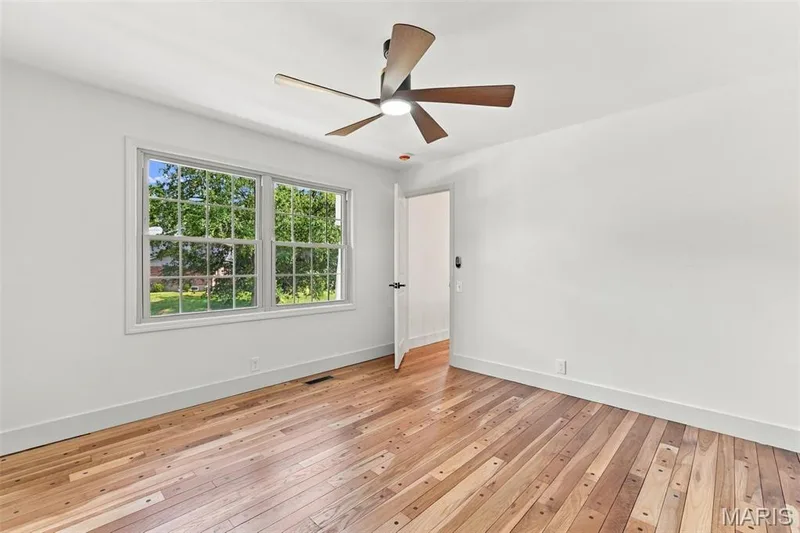 Bedroom 2 Wood-finish flooring, white walls, and a contemporary ceiling fan with integrated lighting — 621 Claymont Estates Drive, Chesterfield, MO 63017