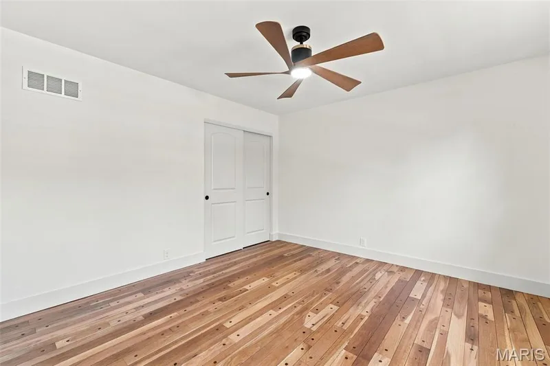 Wood-finish flooring, white walls, and a modern ceiling fan with integrated lighting — 621 Claymont Estates Drive, Chesterfield, MO 63017