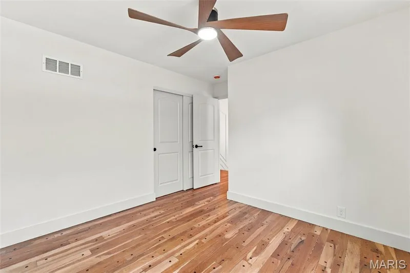 Hardwood flooring, recessed ceiling light, modern ceiling fan, white paneled doors, white walls — 621 Claymont Estates Drive, Chesterfield, MO 63017