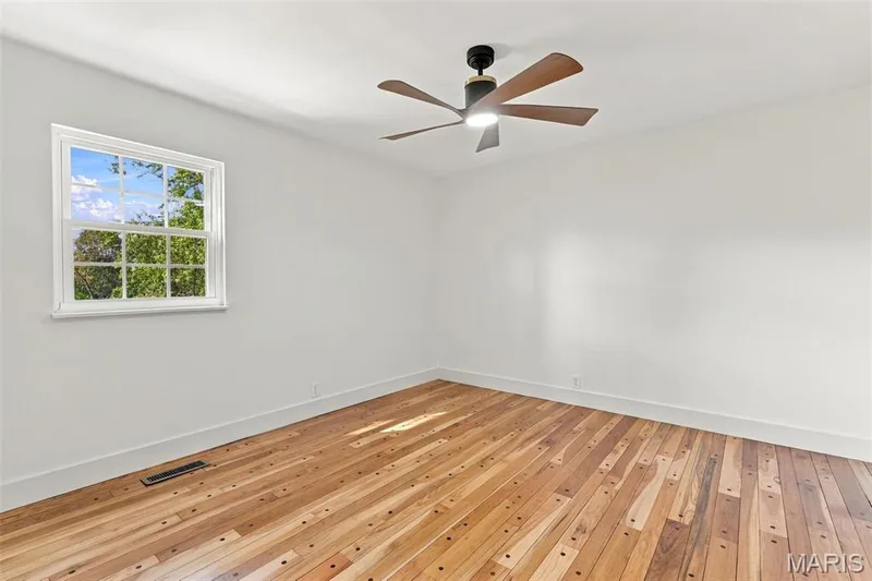 Bedroom 4 Wood-finish flooring, white walls, and a new window — 621 Claymont Estates Drive, Chesterfield, MO 63017
