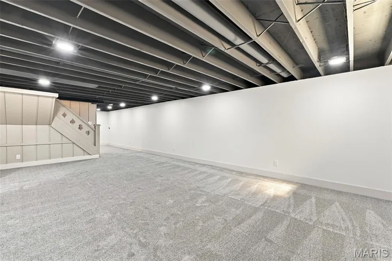Spacious room featuring light gray carpet, white walls, exposed ceiling joists, and recessed lighting — 621 Claymont Estates Drive, Chesterfield, MO 63017