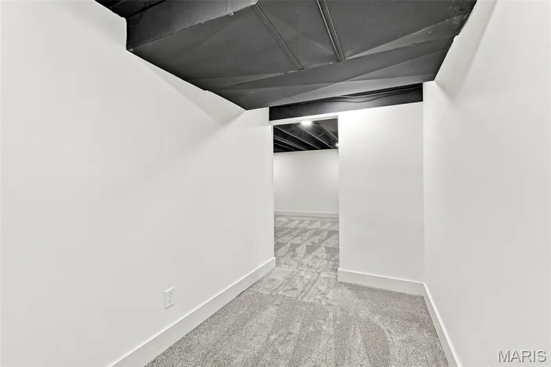 Exercise or play room White painted walls with trim, dark exposed ceiling, and patterned carpeting — 621 Claymont Estates Drive, Chesterfield, MO 63017