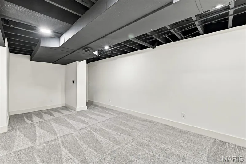 Spacious Home Office or Guest Room room featuring light-colored carpet, white walls, and an exposed dark-painted ceiling with recessed lighting — 621 Claymont Estates Drive, Chesterfield, MO 63017