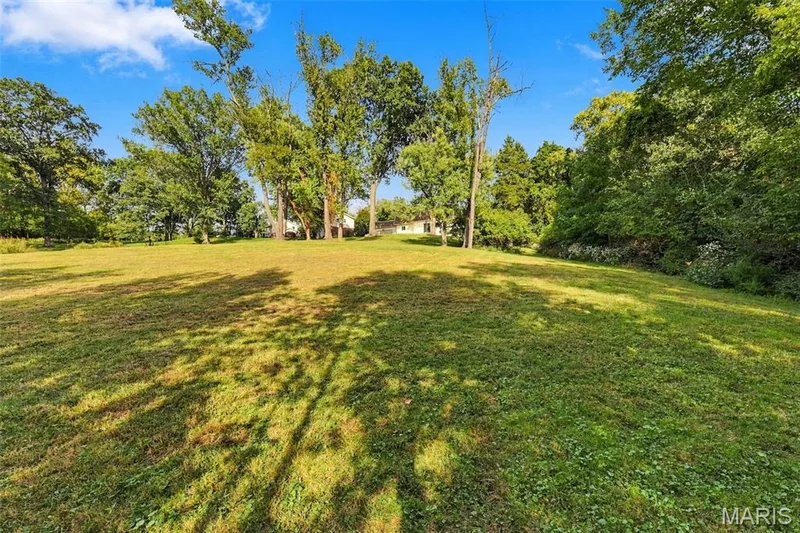 Expansive grassy lot featuring mature trees and a gently sloping terrain — 621 Claymont Estates Drive, Chesterfield, MO 63017