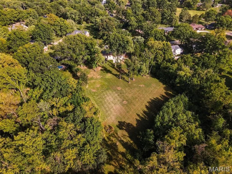 Expansive lot with a large grassy area surrounded by mature trees — 621 Claymont Estates Drive, Chesterfield, MO 63017