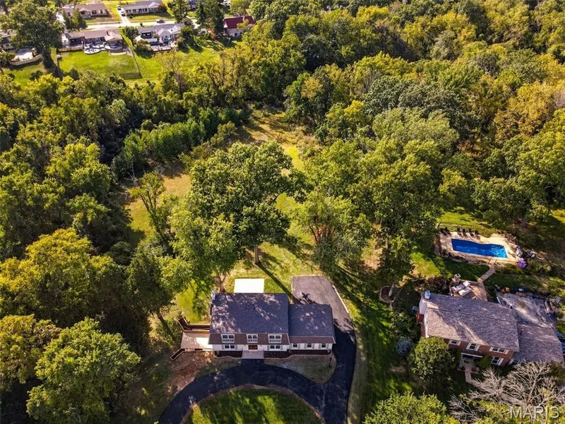 Expansive wooded lot with a circular driveway and mature trees — 621 Claymont Estates Drive, Chesterfield, MO 63017