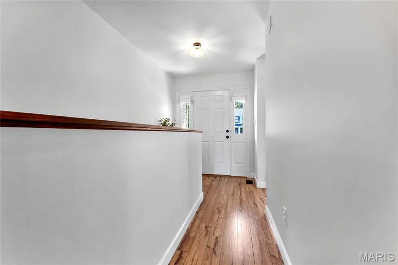 Entryway with wood-finish flooring, white walls, and a white front door featuring sidelight windows — 5507 Dressel Drive, Cottleville, MO 63304