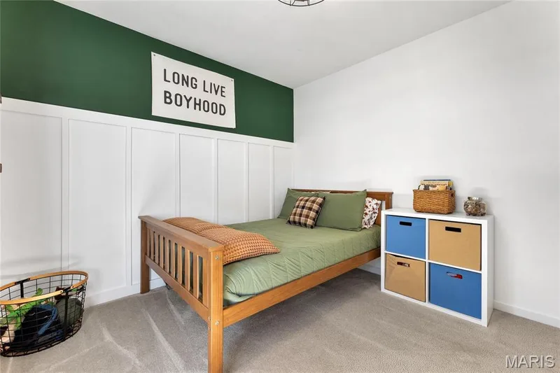Feature wall with board and batten paneling, contrasting green painted accent wall, light-toned carpeting, and a white ceiling — 5507 Dressel Drive, Cottleville, MO 63304