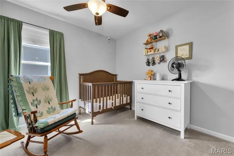 Carpeted flooring with a window featuring blinds and drapes, a ceiling fan with integrated lighting, and neutral wall paint — 5507 Dressel Drive, Cottleville, MO 63304
