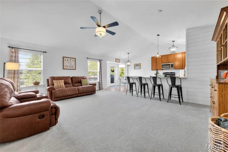 Vaulted ceiling with a ceiling fan, light gray carpeting, and multiple windows — 5507 Dressel Drive, Cottleville, MO 63304