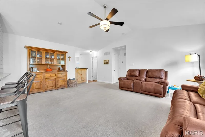 Vaulted ceiling with an attached ceiling fan, light-toned carpeting, and white wall finishes — 5507 Dressel Drive, Cottleville, MO 63304