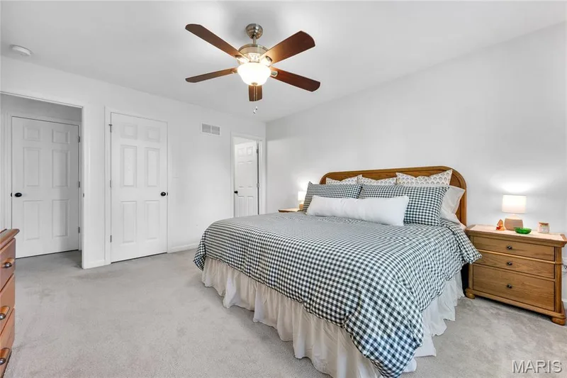 Light-colored wall-to-wall carpeting, white paneled doors with dark hardware, and a ceiling fan with light fixture — 5507 Dressel Drive, Cottleville, MO 63304