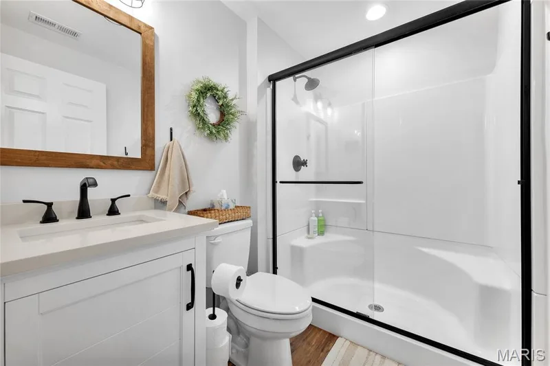 White vanity with shiplap-style cabinetry and matte black hardware — 5507 Dressel Drive, Cottleville, MO 63304