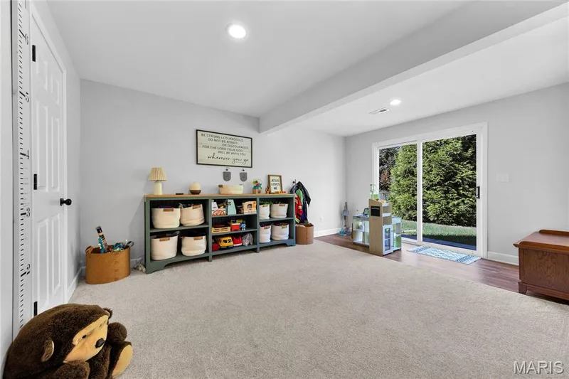 Recessed lighting, light gray wall color, sliding glass door, outdoor green space, and wood-finish flooring — 5507 Dressel Drive, Cottleville, MO 63304