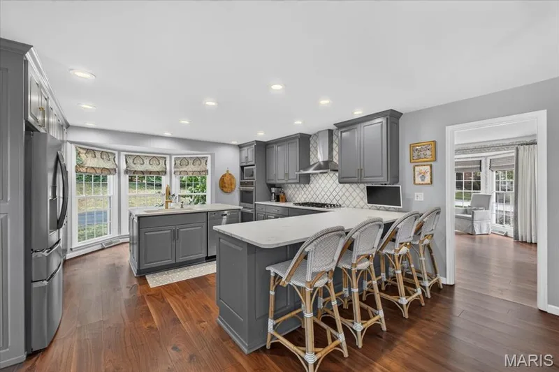 The eat-in kitchen is very stylish with it's dark painted cabinetry. Counter seating for 4 — 1165 Templeton Place, Chesterfield, MO 63017