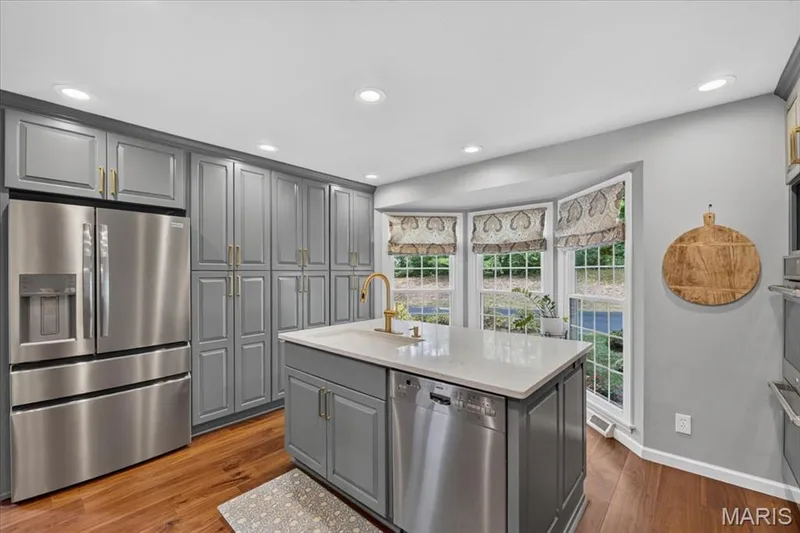 The center island has a prep sink and dishwasher — 1165 Templeton Place, Chesterfield, MO 63017