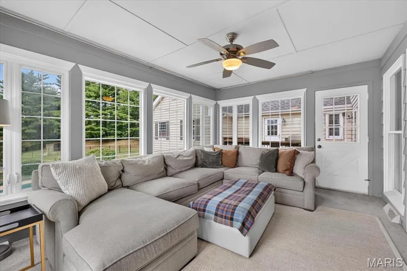 The sun room is used year round as an extra family room, offering a great view of pool and easy access to deck — 1165 Templeton Place, Chesterfield, MO 63017
