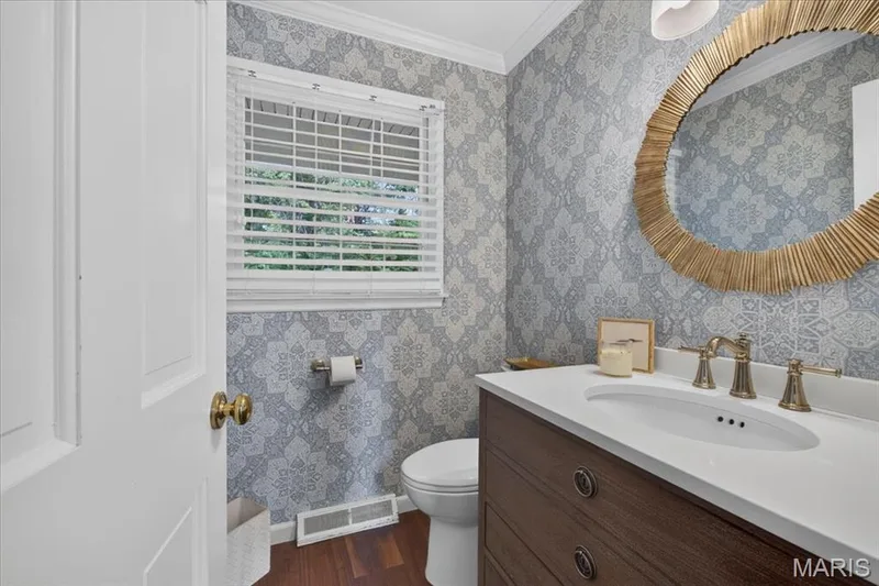 The main floor powder room is off the kitchen and mudroom. More cute wallpaper included. — 1165 Templeton Place, Chesterfield, MO 63017