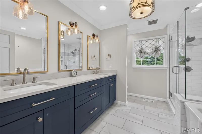 The second level hallway bath is nicely updated with a double vanity, separate tub and shower — 1165 Templeton Place, Chesterfield, MO 63017