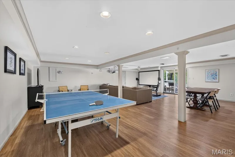 The finished lower level has a large recreation space - walk out to pool and covered patio — 1165 Templeton Place, Chesterfield, MO 63017