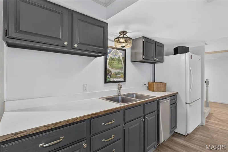 A practical wet bar and extra fridge in the lower level is ideal for pool parties — 1165 Templeton Place, Chesterfield, MO 63017