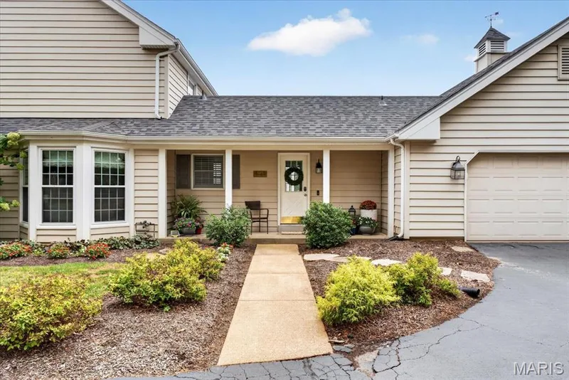The side patio is as charming as it is functional; located off the mudroom with a sidewalk to driveway. Attached 2-car garage — 1165 Templeton Place, Chesterfield, MO 63017