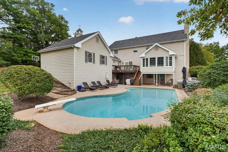 The beautiful in-ground pool is tucked behind home — 1165 Templeton Place, Chesterfield, MO 63017