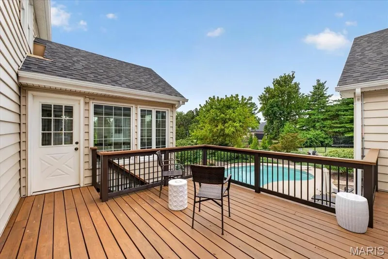 The upper deck with newer railing provides an additional outdoor area and is accessible to sunroom, plus has convenient stairs to pool — 1165 Templeton Place, Chesterfield, MO 63017