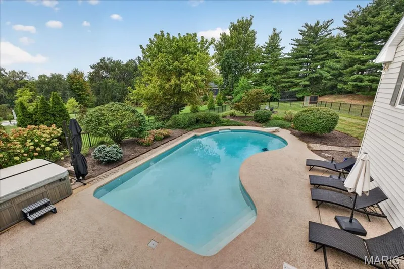 The private, fenced back yard has  established landscaping around pool — 1165 Templeton Place, Chesterfield, MO 63017