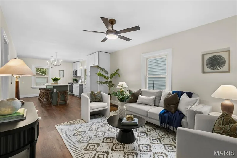 Open-concept living space featuring wood-finish flooring, a modern ceiling fan, and recessed lighting — 924 N Benton Avenue, St Charles, MO 63301