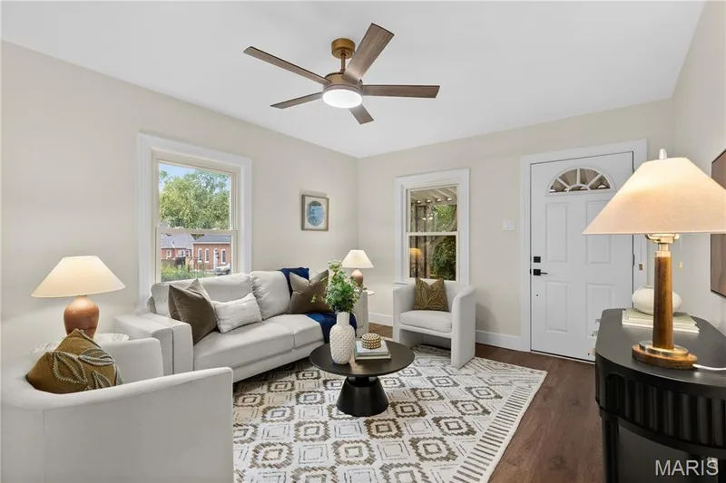 Bright living area with recessed lighting, wood-finish flooring, a ceiling fan with integrated lighting, and multiple windows — 924 N Benton Avenue, St Charles, MO 63301