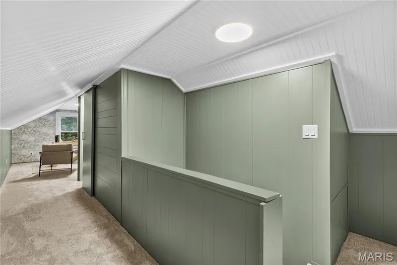 Angled ceiling with horizontal paneling, recessed lighting, carpet flooring, and paneled wall finishes — 924 N Benton Avenue, St Charles, MO 63301