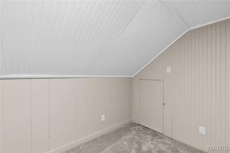 Sloped ceiling with white beadboard, vertical paneling, and wall-to-wall carpeting — 924 N Benton Avenue, St Charles, MO 63301