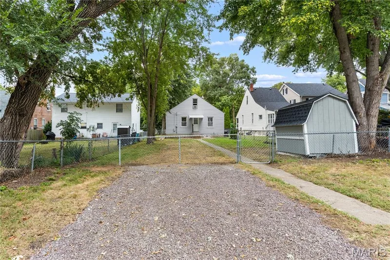 Gravel driveway with chain link fencing and gate — 924 N Benton Avenue, St Charles, MO 63301
