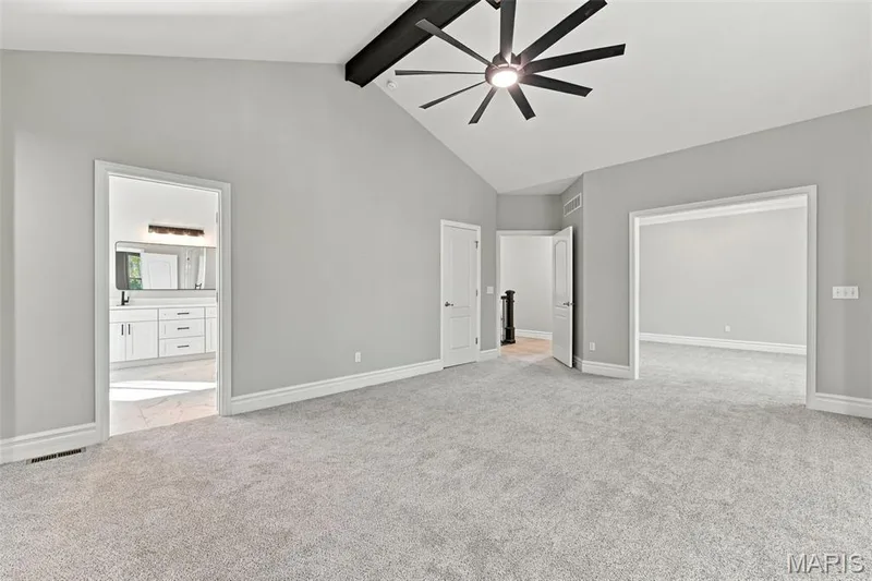 Vaulted ceiling, exposed ceiling beam, contemporary ceiling fan, light gray wall paint, light gray carpeting — 1580 Madre Drive, Foristell, MO 63348