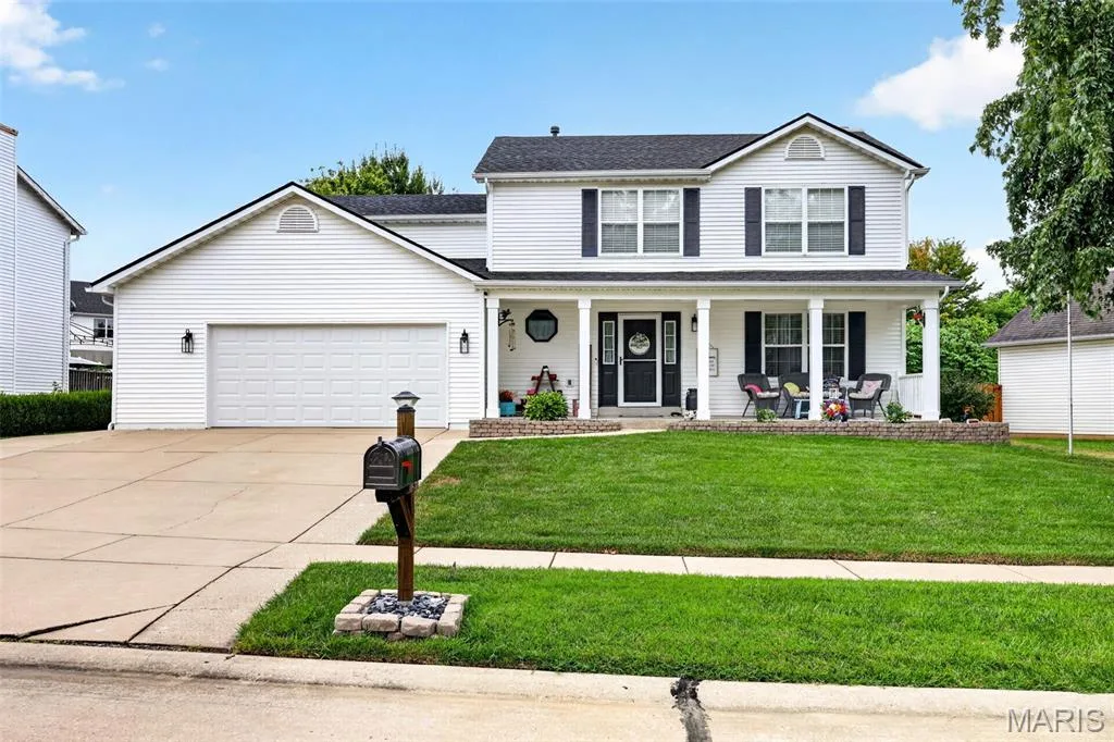 Two-story  with white siding, a covered front porch, and a two-car garage — 2750 Red Cedar Parc Drive, O'Fallon, MO 63368