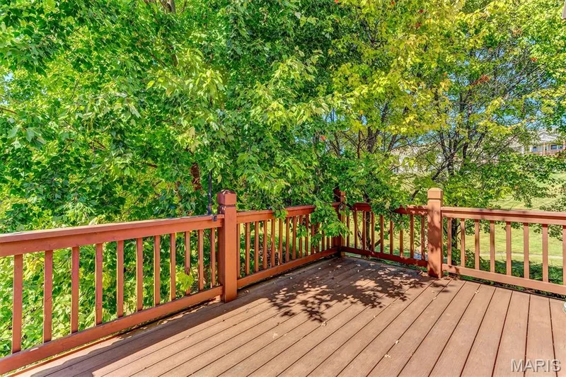 View into tree-lined common ground from oversized deck. — 18 Country Bluff Court, St Charles, MO 63301